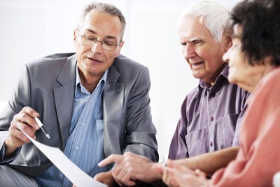 Financial consultant presents bank investments to a senior couple.